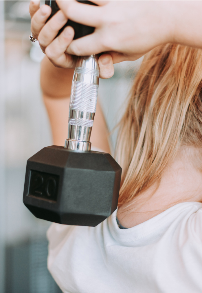 Person lifting dumbbell behind their head.